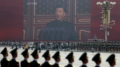 A huge screen shows Chinese President Xi Jinping delivering a speech at the start of a parade to mark the 70th anniversary of the founding of the People's Republic of China. AP Photo