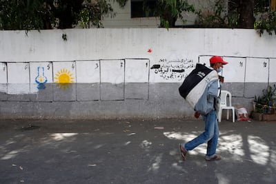 Electoral paintings in Casablanca of political party logos. The lamp represents the Justice and Development Party and the sun the Renaissance and Virtue Party. AP