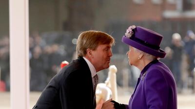 King Willem-Alexander of the Netherlands greets Queen Elizabeth II upon his arrival to inspect an honour guard during a Ceremonial Welcome on Horse Guards Parade in London. Matt Dunham - WPA Pool /Getty Images
