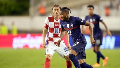 France's Christopher Nkunku, front, duels for the ball with Croatia's Luka Modric. AP Photo