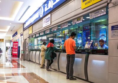 Blockchain could cut the costs of cross-border payments, a Moody's report said. Victor Besa / The National