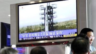 South Koreans watch a television showing a missile launch by North Korea at the Seoul Railway Station.
