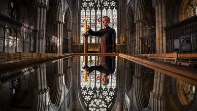 The Very Rev John Dobson, Dean of Ripon, lights a candle on Tuesday to mark the second anniversary of the first national coronavirus lockdown, at Ripon Cathedral, North Yorkshire. PA