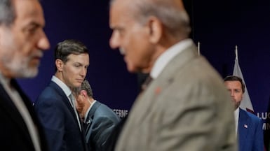 US Vice President JD Vance looks on next to U. S. President Donald Trump's son-in-law Jared Kushner, as Iran's Foreign Minister Abbas Araqchi shakes hands with Pakistan's Prime Minister Shehbaz Sharif, prior to a quadrilateral meeting between the United States, Iran, Pakistan and Qatar at the Burgenstock luxury hotel complex overlooking Lake Lucerne, Switzerland, on June 21, 2026, as part of high-level talks aimed at advancing a deal to end the Middle East conflict. A new round of negotiations over the Middle East war was set to kick off on June 21, 2026 with Iranian negotiators arriving in the Swiss host city hours ahead of US Vice President JD Vance, even as Tehran said it was closing the Strait of Hormuz again over Israeli attacks in Lebanon. (Photo by Nathan Howard / POOL / AFP)