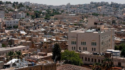 A view of the Israeli settlement point of Beit Romano in the midst of Palestinian buildings, with the Ibrahimi Mosque, also called Tomb of the Patriarchs, in the background, in the city of Hebron in the occupied West Bank. AFP