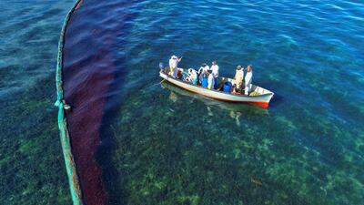 A drone image shows fishermen on a boat as they volunteer near the area where the bulk carrier ship MV Wakashio, belonging to a Japanese company but Panamanian-flagged, ran aground on a reef, at Riviere des Creoles, Mauritius. REUTERS