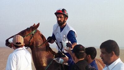 Sheikh Mohammed takes a break during a 100-kilometre horse race in Cairo in May 2000. He won in five hours and 34 minutes.