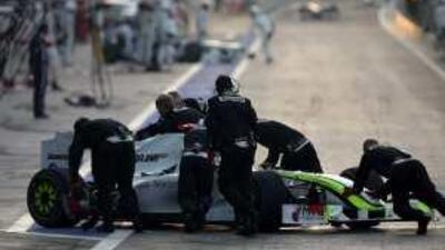 Jenson Button's car is pushed away.