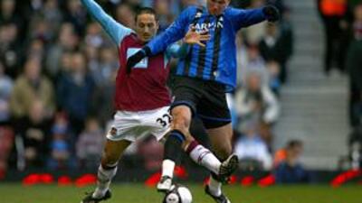 West Ham's David Di Michele, left, tackles Didier Digard.