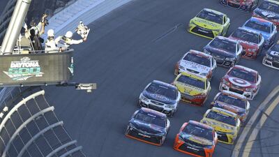 Denny Hamlin, left, and Martin Truex Jr, right, race to the checkered flag on the last lap of the Nascar Daytona 500 at Daytona International Speedway in Daytona Beach, Fla., Sunday, Feb. 21, 2016. (AP Photo/David Graham)