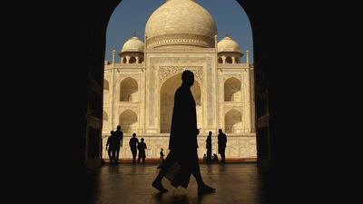 A tourist walks past the Taj Mahal in Agra, India. Emirates Airline and flydubai are increasing their capacity to meet the demand for seats. Mark Kolbe / Getty Images