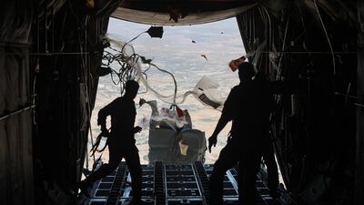 A Jordanian C-130 military aircraft airdrops aid supplies over the Gaza Strip. Getty Images