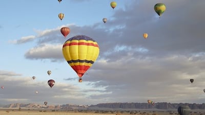 Hot air balloons soaring above the AlUla desert