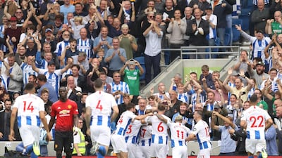 Glenn Murray celebrates with teammates after scoring his team's first goal. Getty