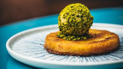 Kunefe, which is baked kadayif pastry, melted Majdule cheese, rose and orange blossom syrup and pistachio ice cream