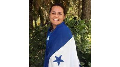 Heidi Kramer wraps herself in the Honduran flag as she prepares for the World Cup.