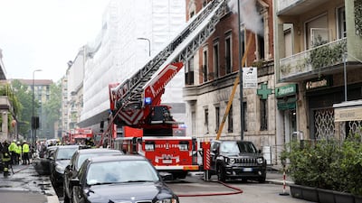 Firefighters dousing a house in Milan. Reuters