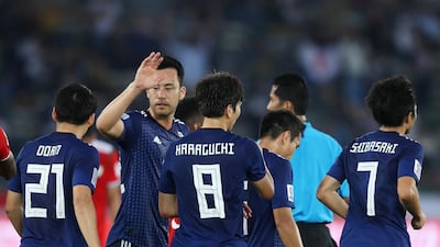 Genki Haraguchi of Japan celebrates with teammates after scoring a goal. Getty Images