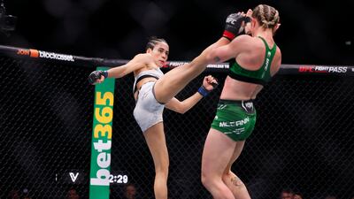 Molly McCann, right, and Bruna Brasil clash in their strawweight battle. McCann won the contest by decision. PA
