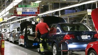 Workers monitor the production line at the Saab automobile factory in Trollhattan, Sweden on October 2007. Bloomberg News