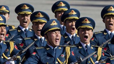 Members of a Chinese honour guard shout as they march during a welcome ceremony for the German chancellor Angela Merkel in Beijing. Ng Han Guan / AP Photo