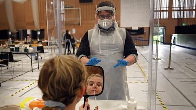 Naomi Carpenter, a 20-year-old sports rehab student at Hull University, takes a swab for a lateral flow Covid-19 test at the campus sports facilities. AFP