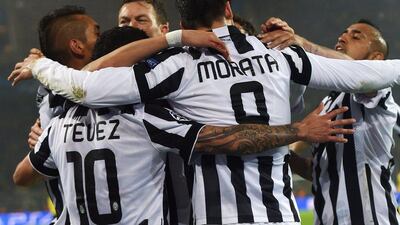 Juventus players Alvaro Morata, right, and Carlos Tevez, left, celebrate with teammates after a goal on Wednesday night in their Champions League last 16 win over Borussia Dortmund. Patrik Stollarz / AFP / March 18 , 2015