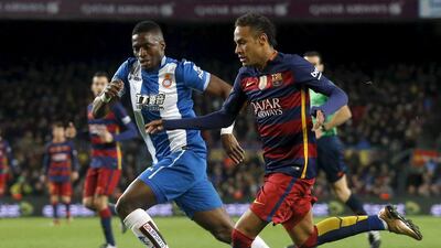 Barcelona’s Neymar (R) vies for the ball against Espanyol’s Pape Diop. REUTERS/Albert Gea