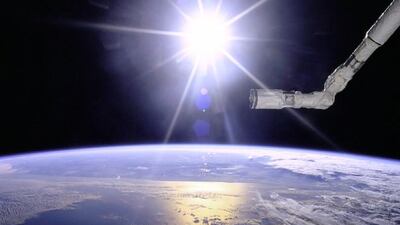 1996: View of the Remote Manipulator System (RMS) end effector over an Earth limb with a solar starburst pattern behind it. Courtesy NASA