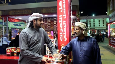 Amr Al Faqih, left and Ahmed Al Kheder both work at the Yemeni Pavilion at the Global Village in Dubai. Satish Kumar / The National