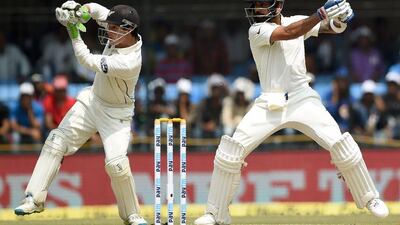 Virat Kohli, right, plays a shot as New Zealand wicketkeeper BJ Watling watches on Day 2. Punit Paranjpe / AFP