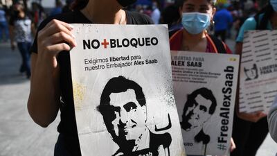 People hold placards with the image of Colombian businessman Alex Saab, who was extradited to the US, during a demonstration demanding his release in Caracas on Sunday. Photo: AFP