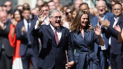 Mr Starmer and his wife, Victoria, wave to well wishers on Downing Street. Getty Images