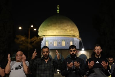Palestinians perform an evening prayer outside the Dome of the Rock shrine in Jerusalem's Al Aqsa Mosque compound on Saturday. AFP