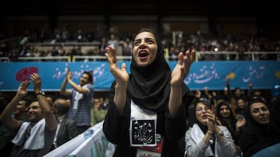 An Iranian woman applauds during a reformists campaign meeting for the upcoming parliamentary elections at Hejab hall in downtown Tehran. Behrouz Mehri / AFP