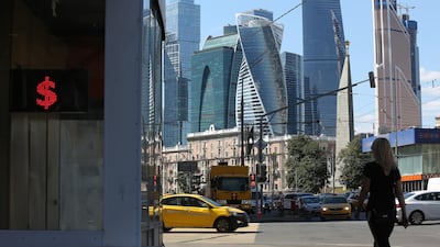Skyscrapers stand in the Moscow City financial district beyond a currency bureau advertising U.S. dollar exchange rates in Moscow, Russia, on Friday, Aug. 10, 2018. President Vladimir Putin’s efforts to protect Russia after past rounds of U.S. sanctions are leaving the economy more insulated even as the threat of further penalties rattles markets this week. Photographer: Andrey Rudakov/Bloomberg