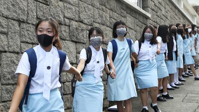 Students form human chain outside the Maryknoll Convent School. AP Photo