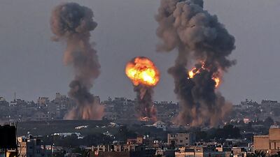 Smoke and a ball of fire rise above buildings in Khan Yunis in the southern Gaza Strip, during an Israeli air strike. AFP