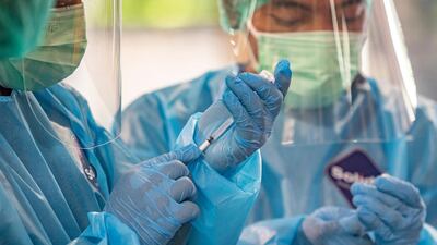 Medical workers prepare Covid-19 vaccine shots during a vaccination drive in Denpasar, Bali, Indonesia. EPA