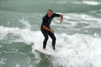 People surf the waves on a blustery day in Dubai. Chris Whiteoak / The National