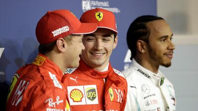 Ferrari driver Charles Leclerc, centre, smiles after taking the first pole position of his career in Bahrain. AP Photo