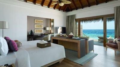 Villas on stilts sit over the Dusit Thani resort's blue lagoon. Courtesy Dusit Thani Maldives