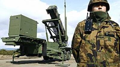 A soldier stands next to a Japanese Self-Defence Force Patriot Advanced Capability-3 (PAC-3) missile unit in Iwate prefecture in northern Japan, yesterday.