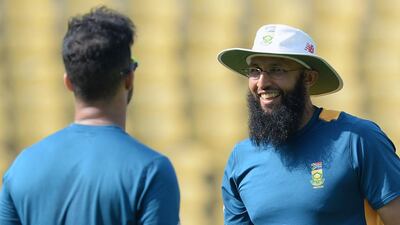 South Africa's captain Hashim Amla (R) talks with teammate JP Duminy during a training session ahead of the third Test cricket match between India and South Africa at The Vidarbha Cricket Association Stadium in Nagpur on November 24, 2015. AFP PHOTO / Indranil MUKHERJEE---- IMAGE RESTRICTED TO EDITORIAL USE - STRICTLY NO COMMERCIAL USE ----