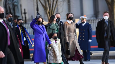 US Vice President Kamala Harris, husband Doug Emhoff, her great niece Amara, and family members walk the abbreviated parade route after US President Joe Biden's inauguration. AFP
