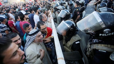 Riot police attempt to disperse crowds during the protest in Baghdad. Reuters