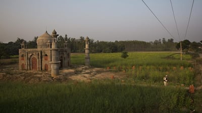Retired postman Faizul Hassan Qadri, 79, leaving the monument he is building for his late wife Tajammuli in the town of Kaser Kalan, in the Indian state of Uttar Pradesh. Bernat Armangue / AP Photo