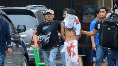 An Indonesian plainclothes policeman detains a terrorist suspect, centre, after an attempted suicide bombing at St Yoseph Catholic Church in Medan, Indonesia on August 28, 2016. Dedi Sinuhaji/EPA