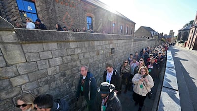 The sun shone as people waited to enter. AFP