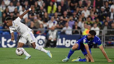 Real Madrid forward Rodrygo breaks clear of a challenge from Getafe defender Domingos Duarte. AFP